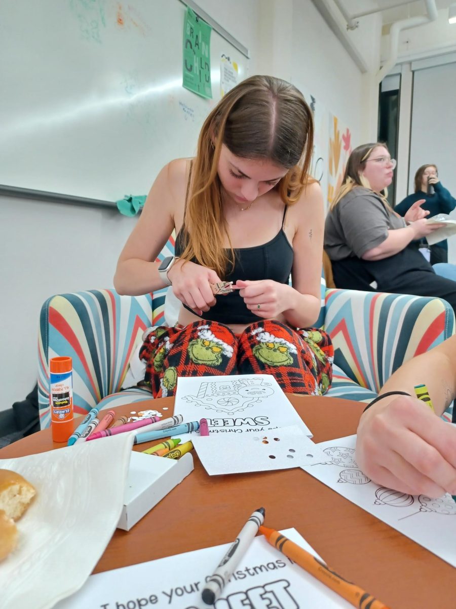 Brenna Johnson working on her Christmas card at AIGA Wrap Up The Semester event on Dec. 6, 2023.