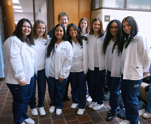 Nursing students huddled together in the College of Nursing, located in Henderson Hall. 