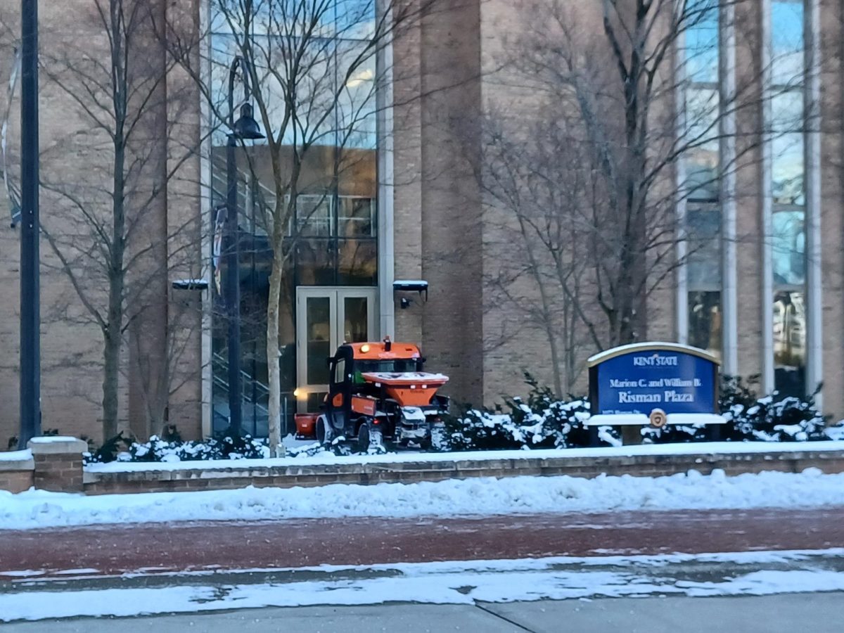 Kent State facilities workers clean up the snow near the Risen Plaza on Jan. 21, 2024.