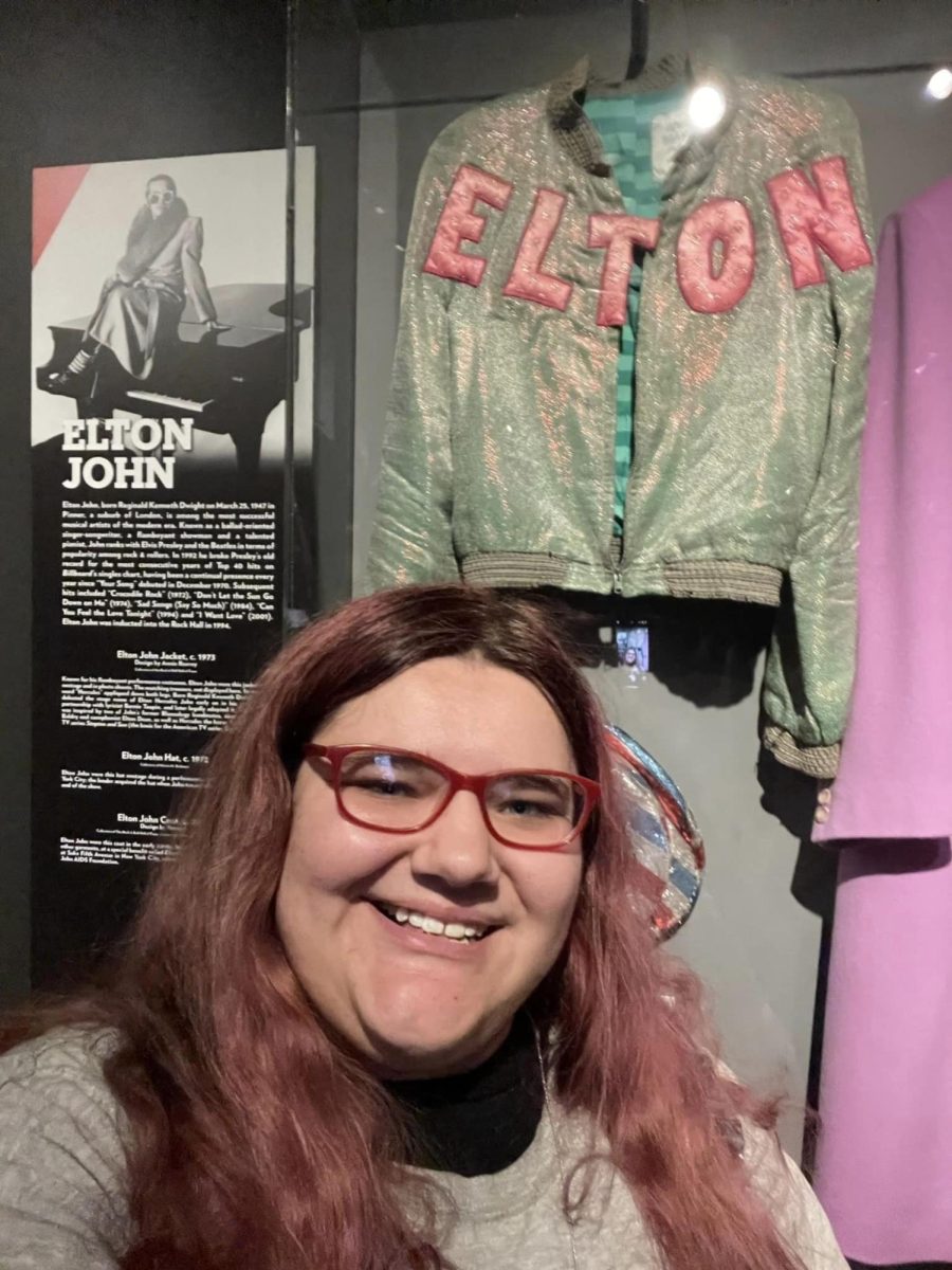 Kentwired staff member Annemarie Karabinus in front of the Rock and Roll Hall of Fame exhibit for Elton John.