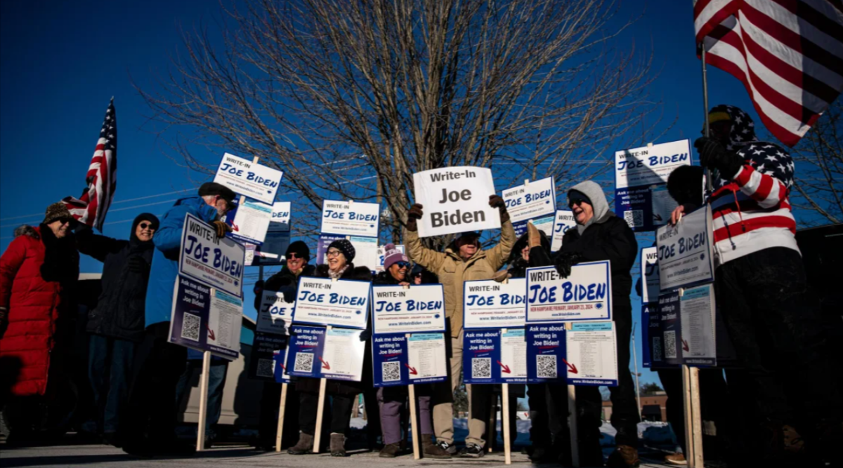 Attendees hold signs during a Write-In Joe Biden campaign Get Out The Vote event in Dover, New Hampshire, US, on Sunday, January 21, 2024.
