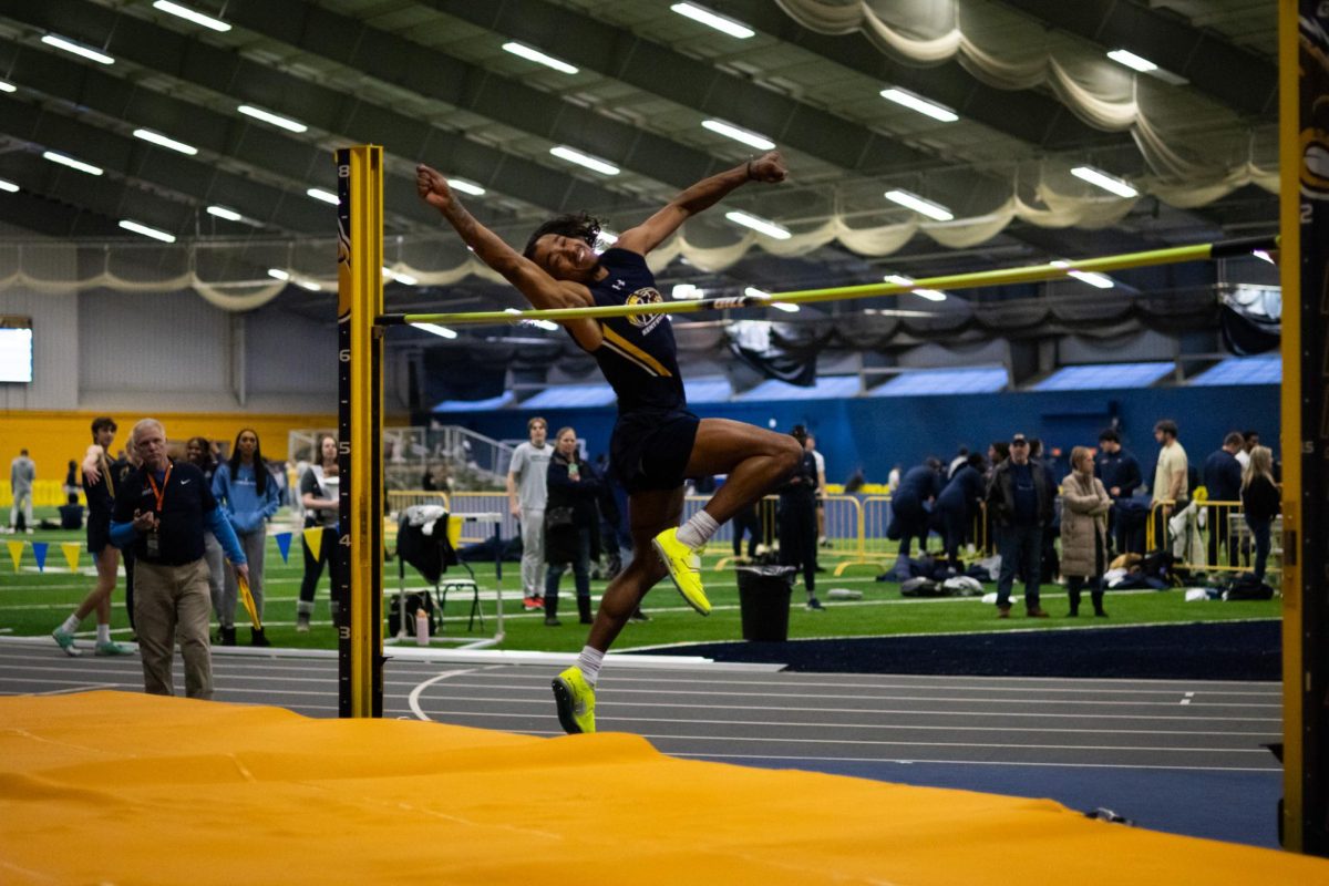 Sophomore Zane Cattage competes in the high jump during the track and field meet against Akron Jan. 19, 2024.