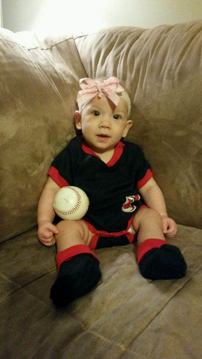 Always prepared for the camera, Aria sits ready with her baseball on Dec. 11, 2016. 