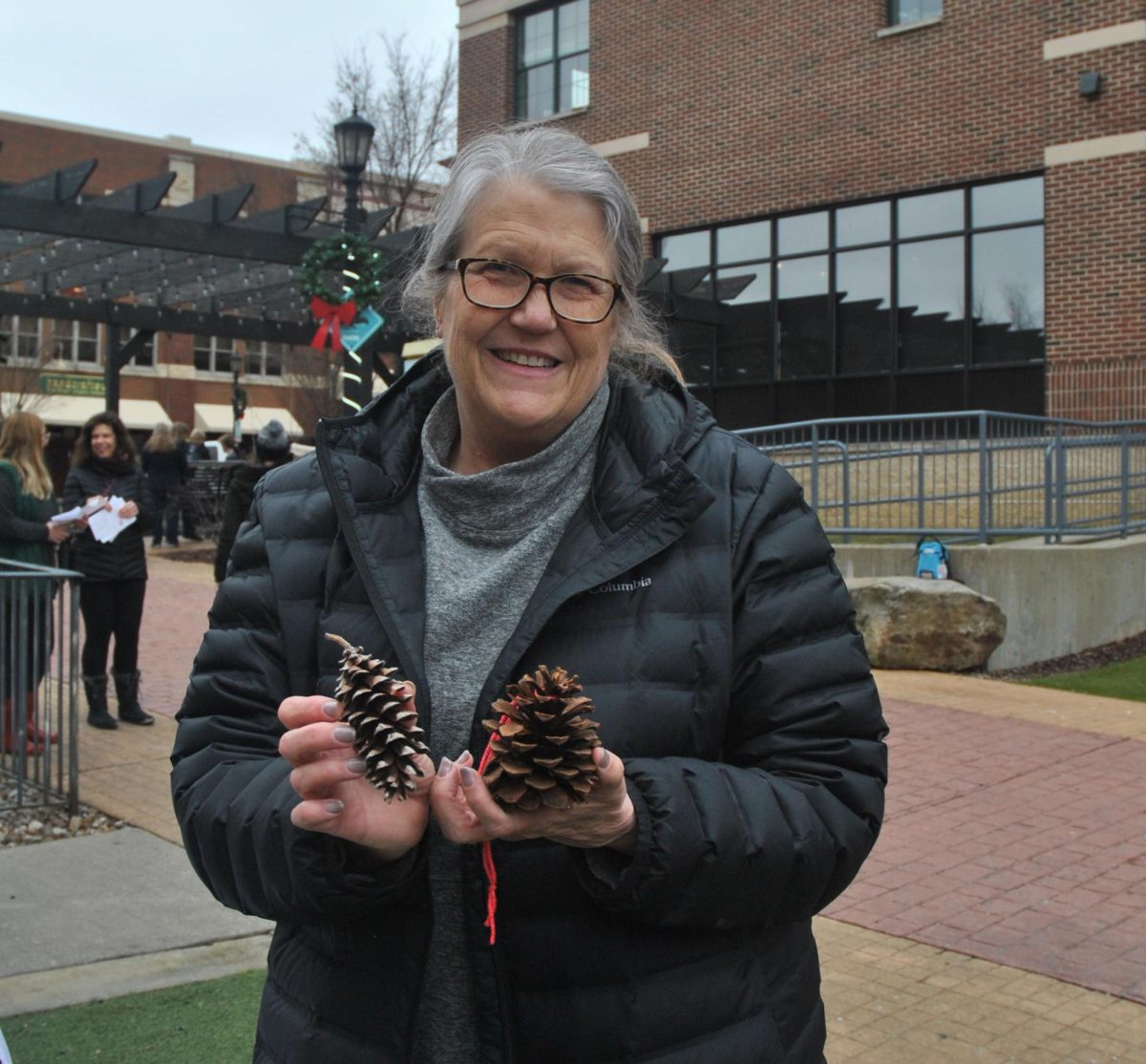 DeeAnn Pochedly a volunteer for Portage Parks, hands out pinecones for a craft during Kents Snow Day on Saturday, January 27th. 