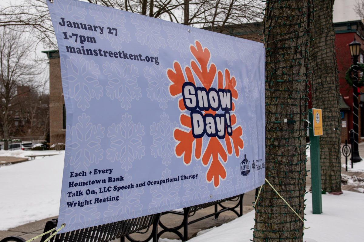 A sign announcing the upcoming Main Street Kent Snow Day hangs in the Hometown Bank Plaza of dowtown Kent on Jan. 22, 2024. 