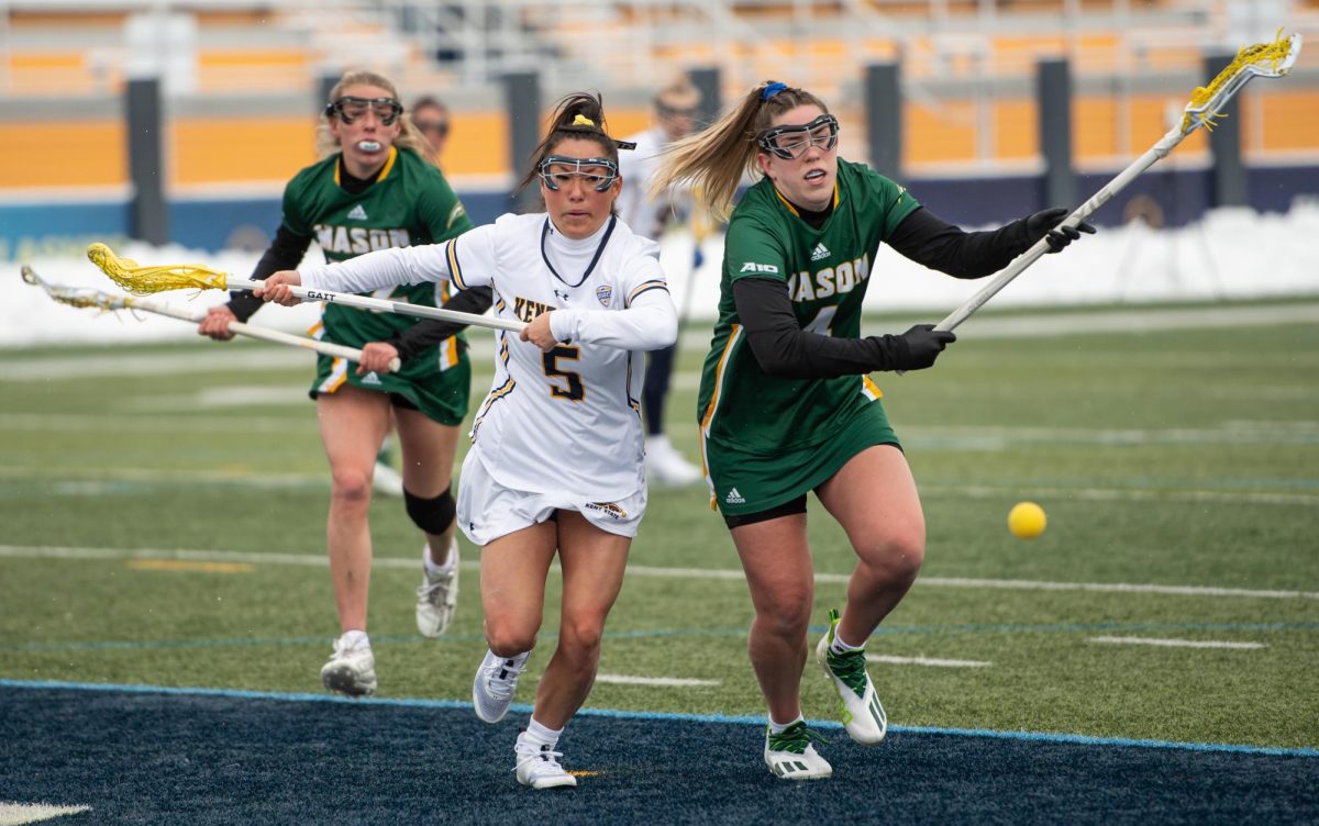 Kent State junior Allie Lee and George Mason senior Ciara Curtis chase down a ground ball during the game on Feb. 17, 2024. 