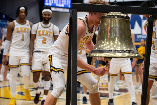 Sophomore Magnus Entenmann rings the bell after the basketball teams victory against Buffalo on Feb. 27, 2024.