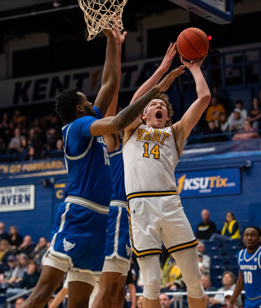 Sophomore Magnus Entenmann shoots the ball around Buffalo defenders attempts to block him during the game against Buffalo on Feb. 27, 2024.