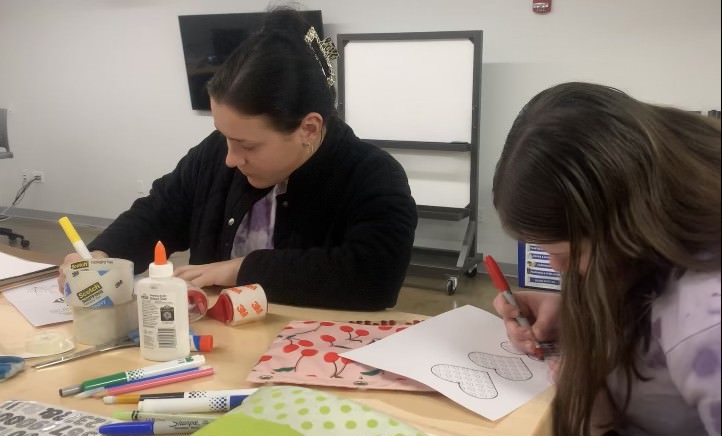 Gerontology Club President, Allison Kidd, and Social Media Director, Erica Crawford, work on Valentine’s Day cards for older adults. 