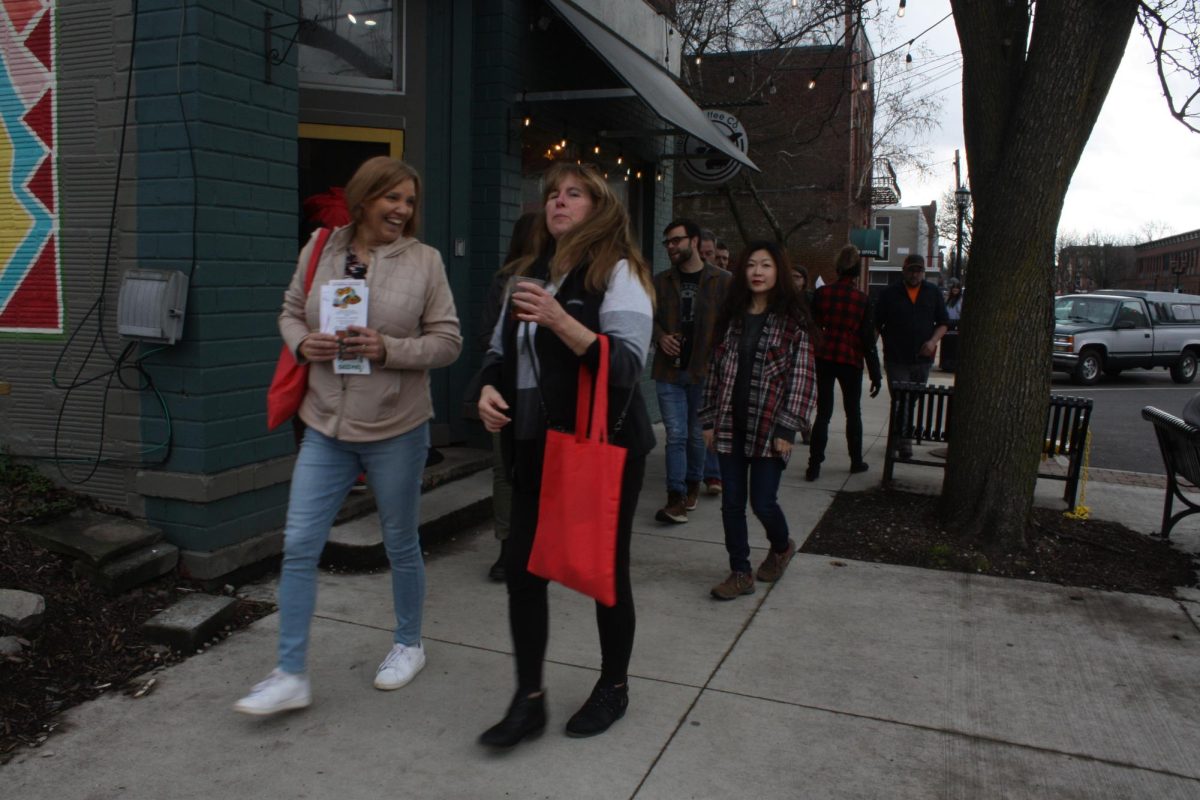 Cheryl Marez (left) and her pickleball group In The Kitchen stroll down Water Street to get more chocolate after stopping for some drinks at Scribbles Coffee Co. on Feb. 10, 2024.