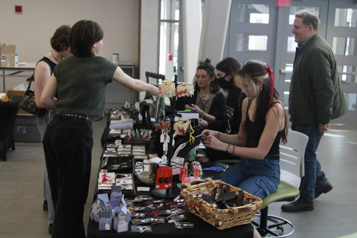 A student purchases handmade jewelry at Kent State Art Clubs annual Valentines Day sale Feb. 9, 2024 