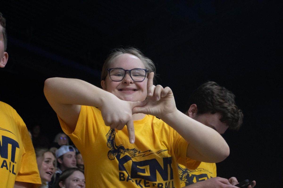 A Kent State student at the James A. Rhodes arena makes a lighting bolt symbol in support of the Flashes on February 23, 2024 during the mens basketball game against Akron.
