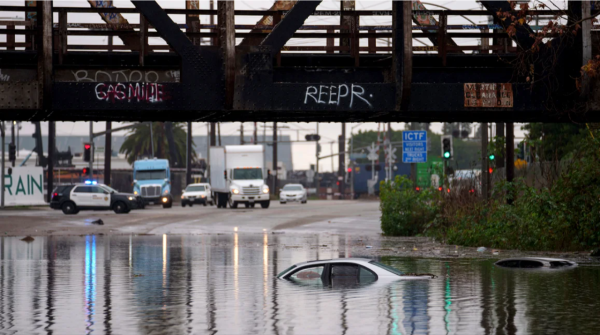 Cars are submerged on a flooded street in Long Beach, California.