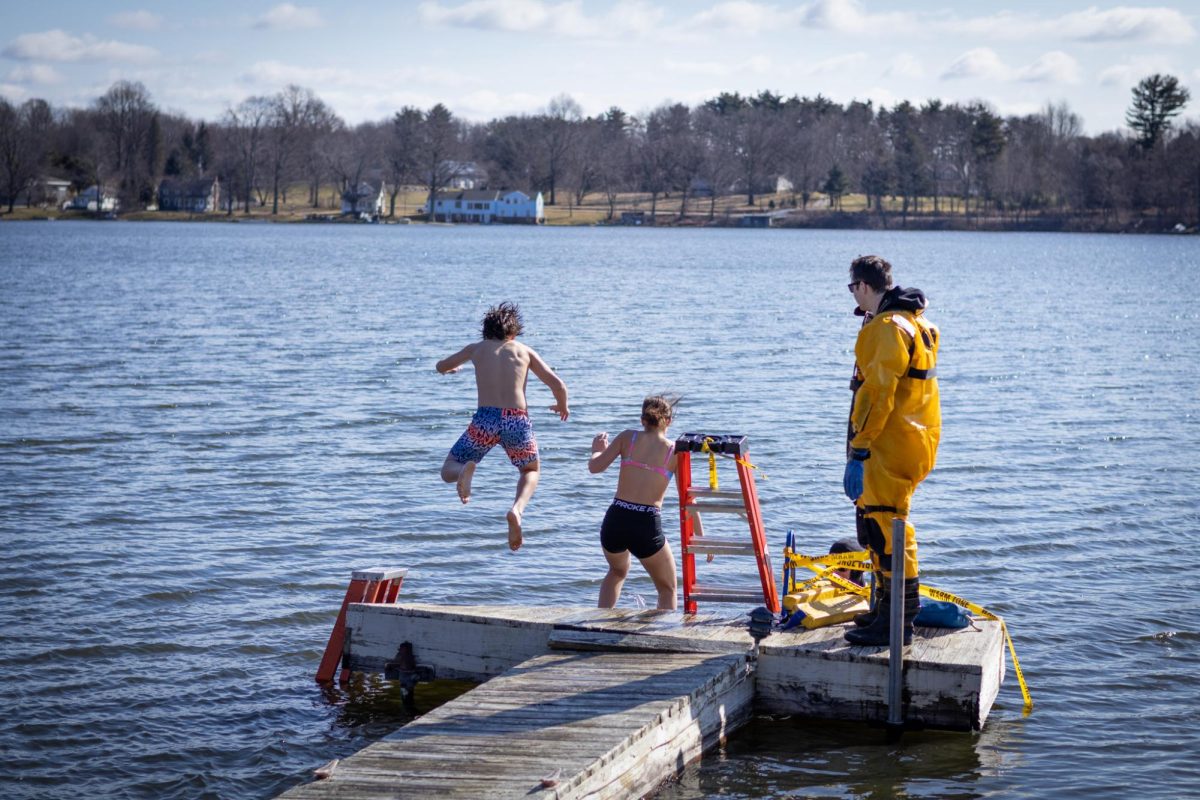 Olivia DeToro and Joey DeToro, students from Streetsboro High School, jump into the cold water during a polar plunge on Feb. 24, 2024.