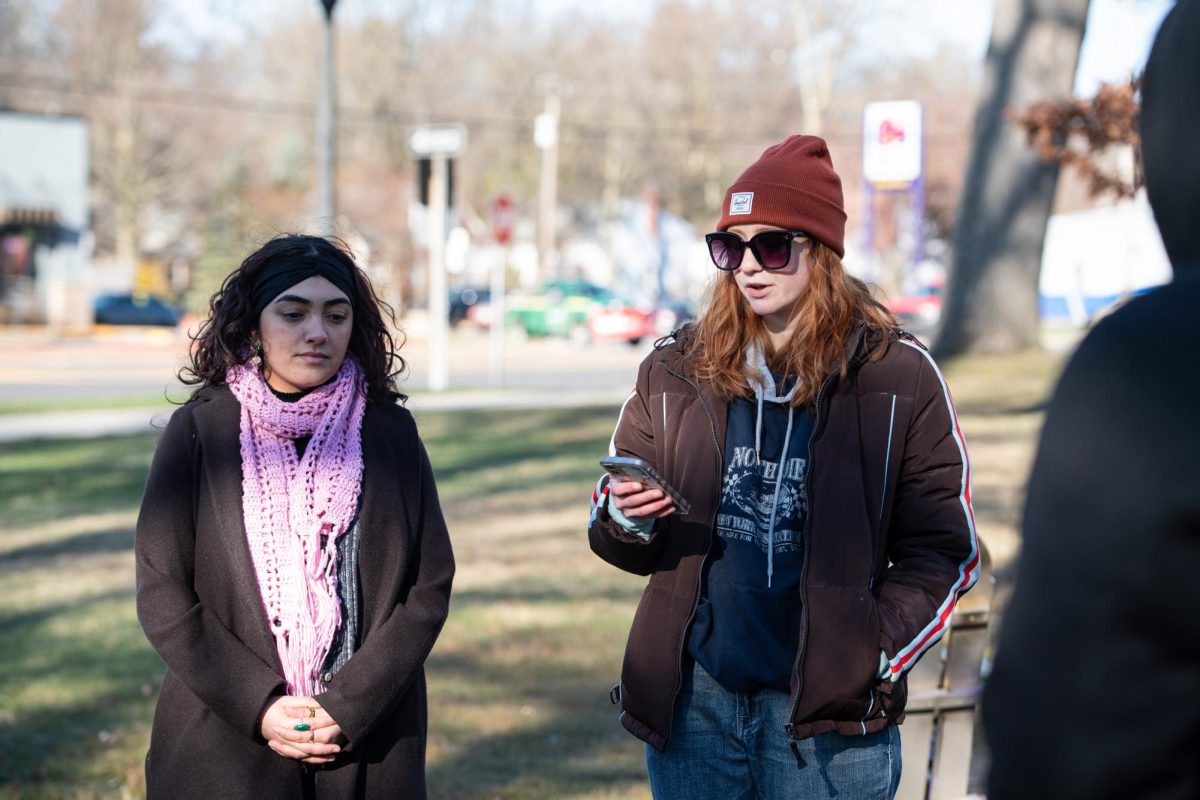 KSURGE President Riley Hudson (right) and Vice President Sohaela Rojas (left) lead the candlelight vigil held in honor of Nex Benedict on March 21, 2024. 