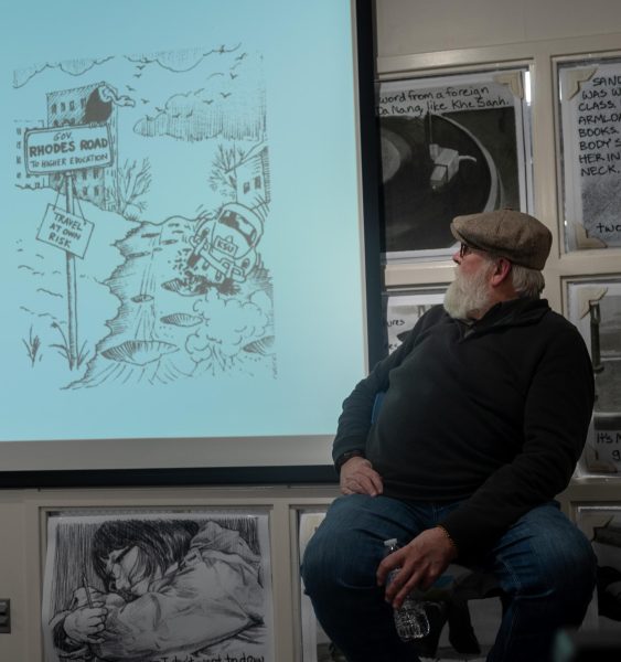 Chuck Ayers discusses one of his political cartoons published in the Daily Kent Stater during the Opening Dialogue series, Graphic Content: Comics of May 4th, at the May 4th Visitors Center on March 20, 2024.