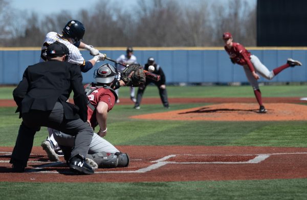With Jake Casey sitting at third, Kent States Brody Williams swings under St. Josephs Ryan DeSantos pitch during their game on March 24, 2024. Williams went 0-1 with two walks in three plate appearances against the Hawks.