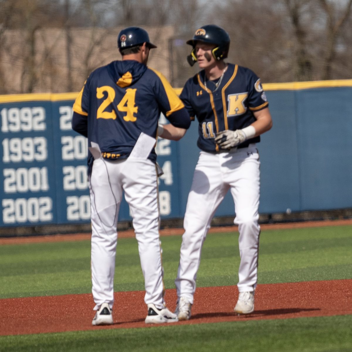 Jeff Duncan (left) confers with Kolton Schaller following Schallers double in the second inning of the Golden Flashes 27-0 blowout of Youngstown State on March 12, 2024.