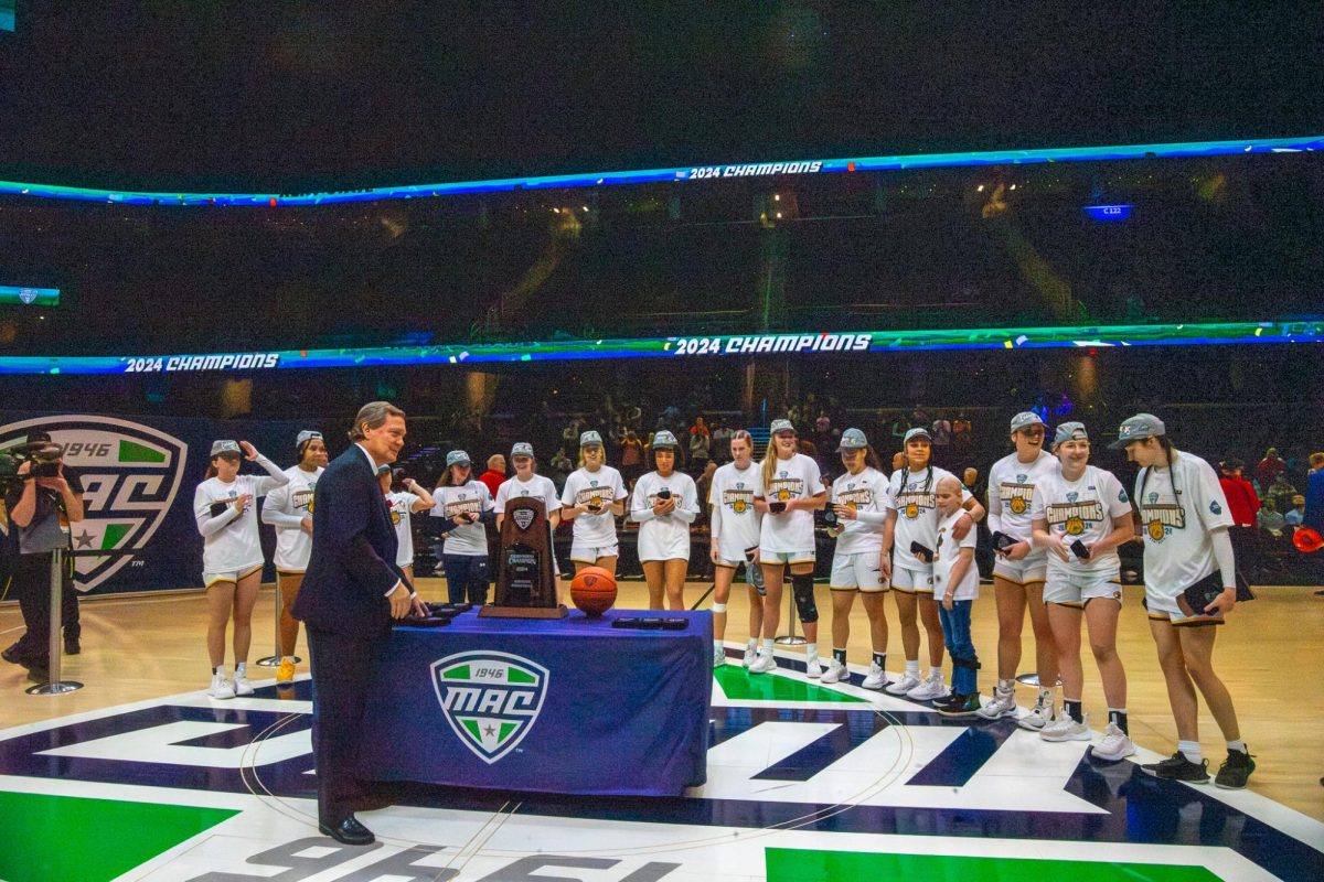The Kent State womens basketball team line up to receive their trophy for winning the MAC Womens Basketball tournament on Saturday, March 16, 2024. 