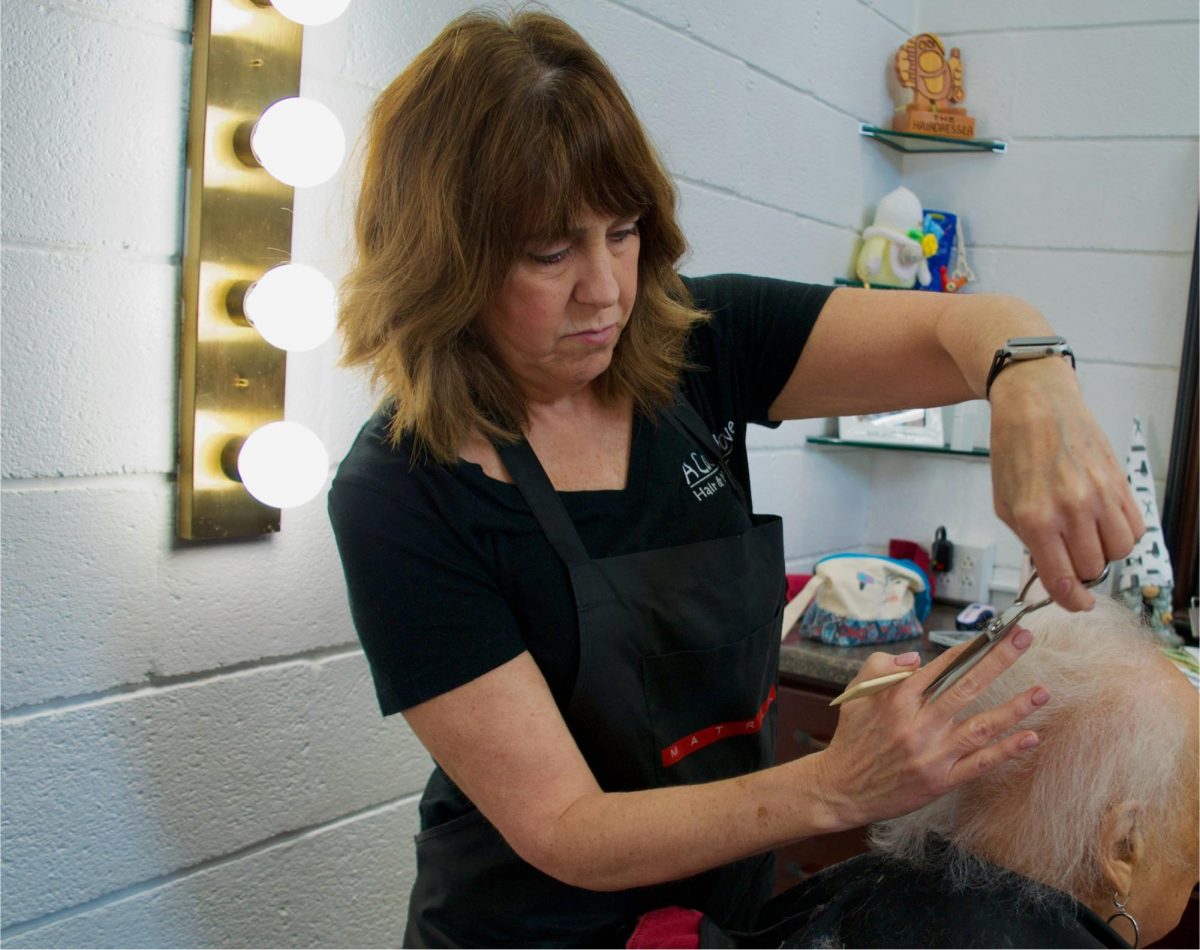 Carrie Shanley cuts hair at A Cut Above Hair and Nail Salon, located at 820 N Mantua St, on March 22, 2024.