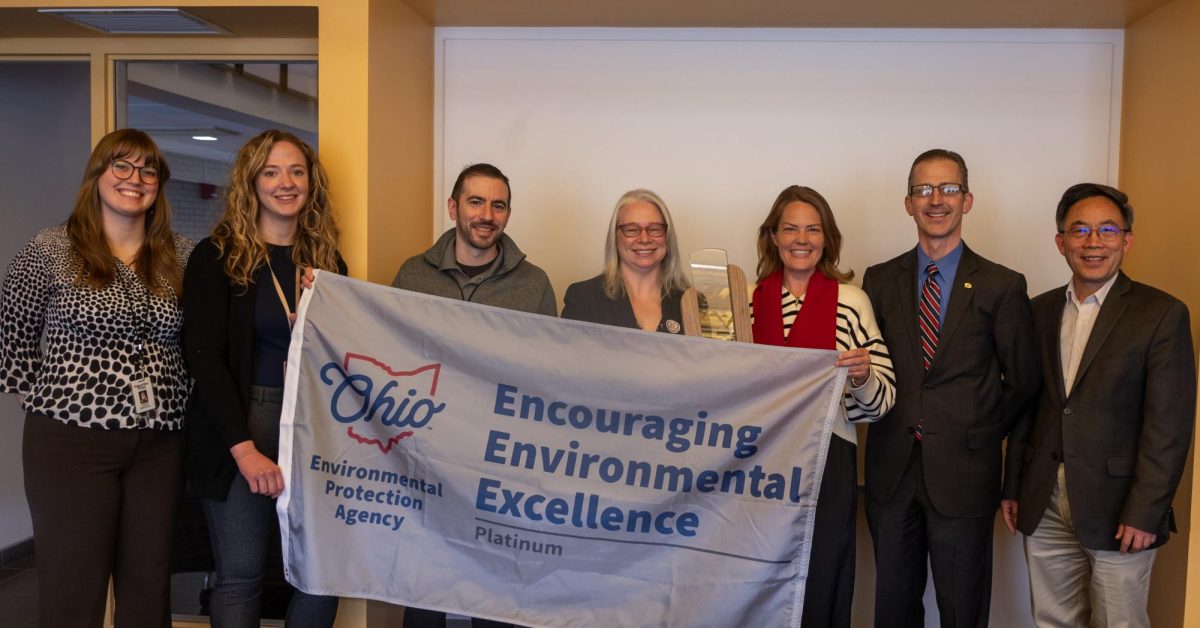 Kent State personnel pose with Anne Vogel, Director of the Ohio EPA and Melanie Knowles, Sustainability Manager for Kent State Facilities when receiving the award and banner for the Platinum Award for Encouraging Environmental Excellence on March 19, 2024.