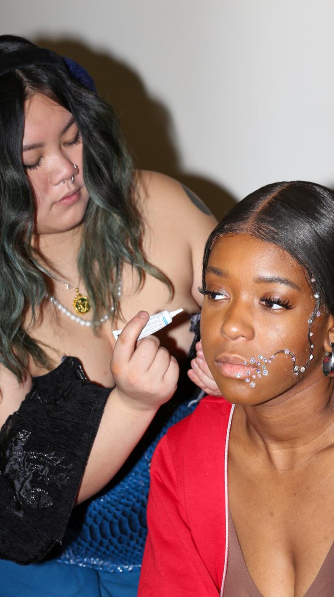 Candace Drew has her make-up done by her designer, Katherine McClure, for the Fabric Pantrys annual fashion show on March 9, 2024.