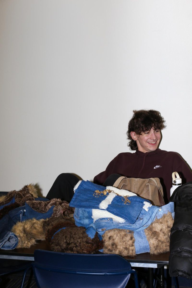 Alex Bayus relaxes before as he prepares to put on his garment for the Fabric Pantrys annual fashion show on March 9, 2024. 