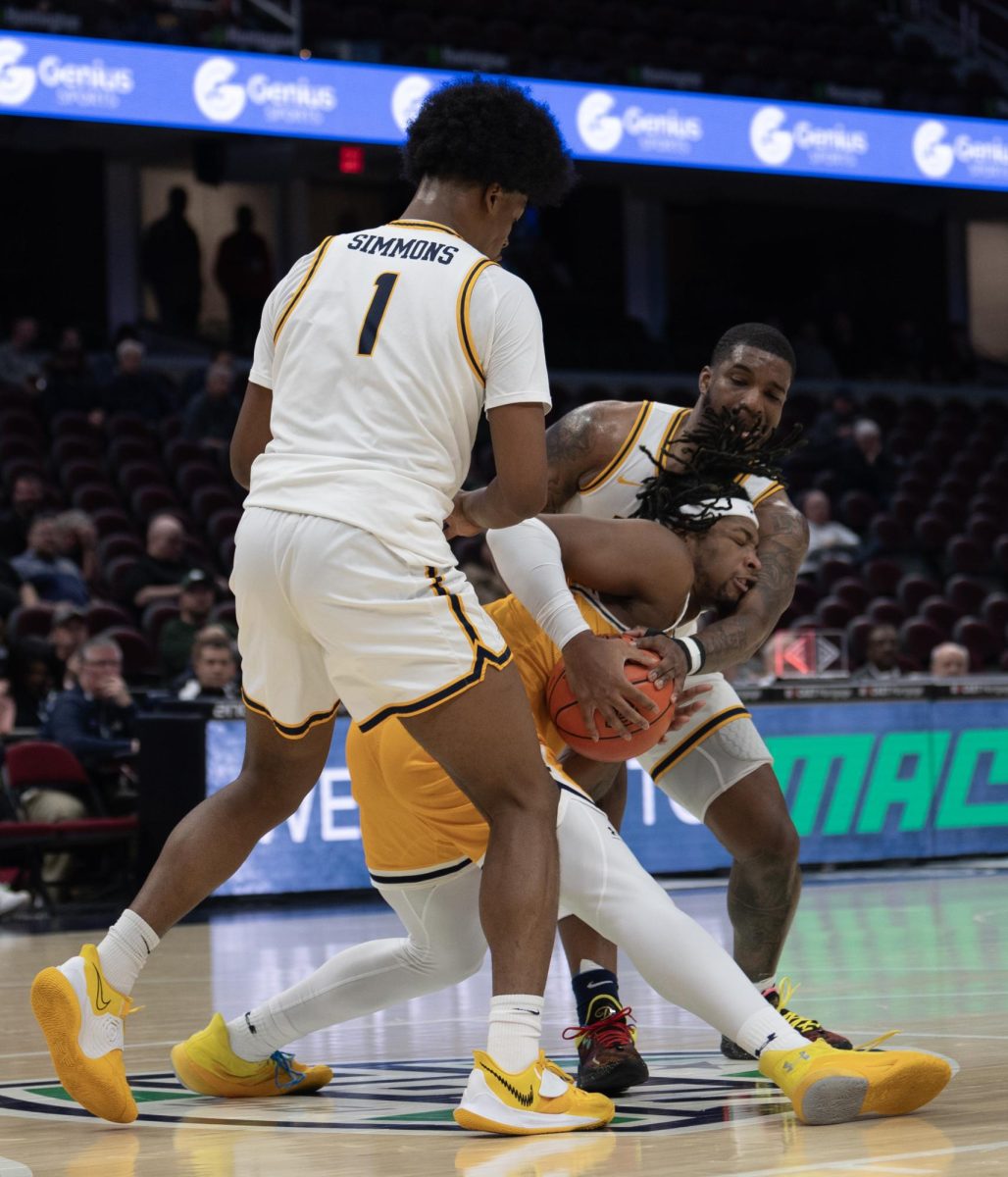 Redshirt junior forward VonCameron Davis drives through a double team of Toledos Javan Simmons (1) and Tyler Cochran during the Mid-American Conference Tournament on March 14, 2024.