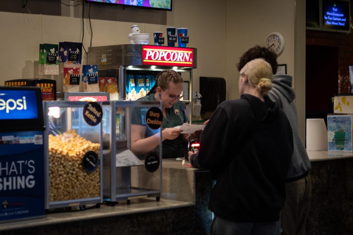 Sonya Boyes helps customers at the counter at Kent Plaza Theater on March 23, 2024.