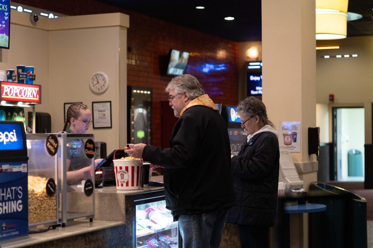Kelly and Cyndi Newsome are at Kent Plaza Theater, a theater that they have been going to since forever. They get popcorn before seeing a movie on March 23, 2024.