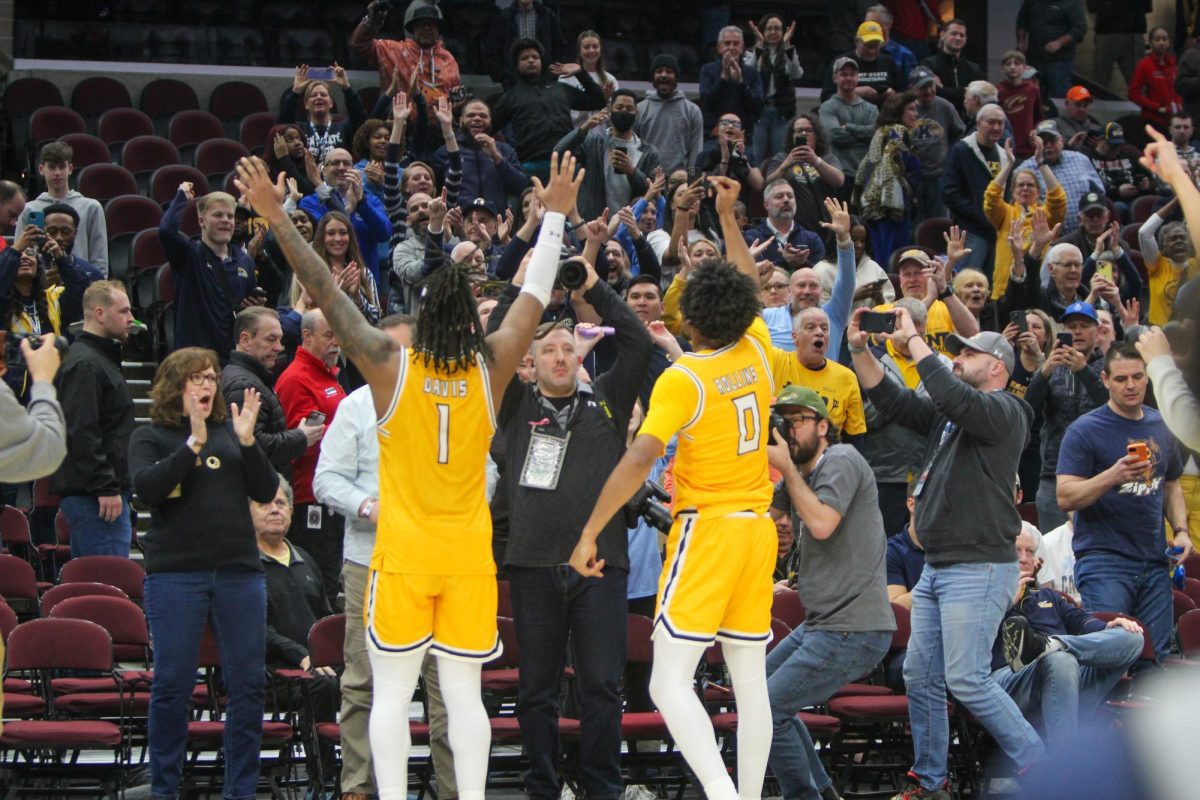 VonCameron Davis and Julius Rollins celebrate with the crowd after their win against the University of Toledo on March 14, 2024.