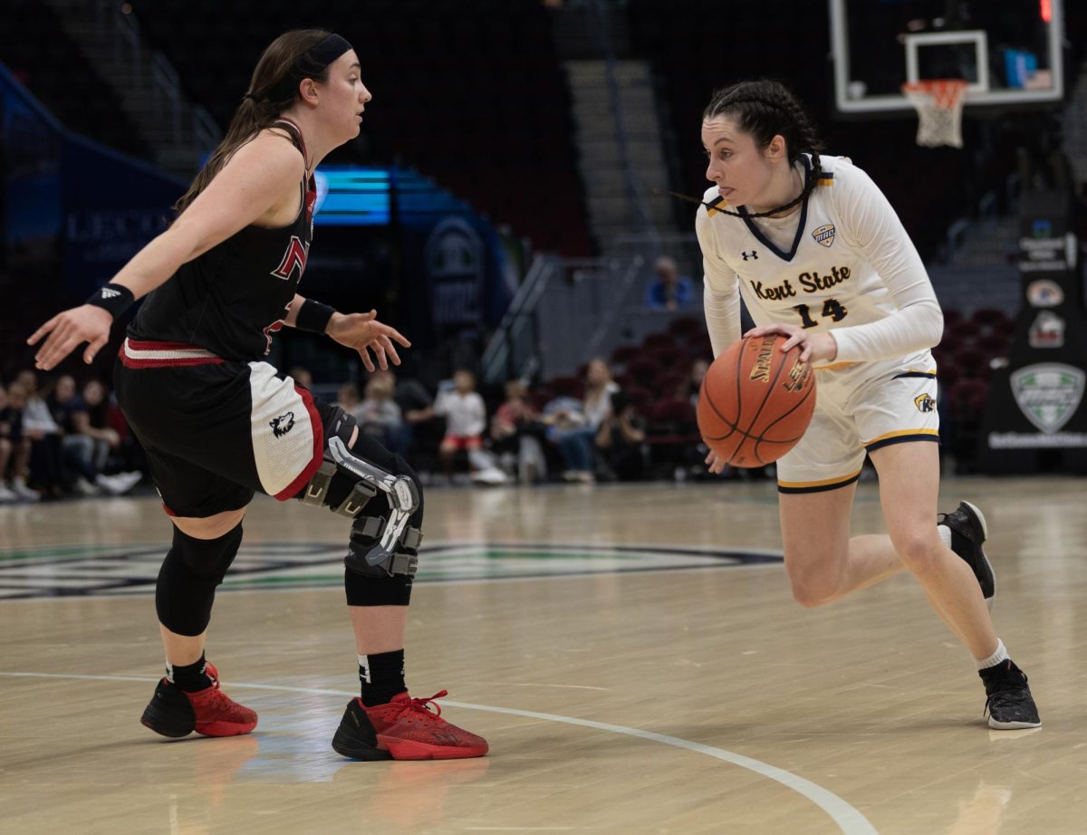 Redshirt Senior Guard Katie Shumate starts to drive past Northern Illinois Sidney McCrea during their Mid-American Conference Quarterfinal game on March 13, 2024.