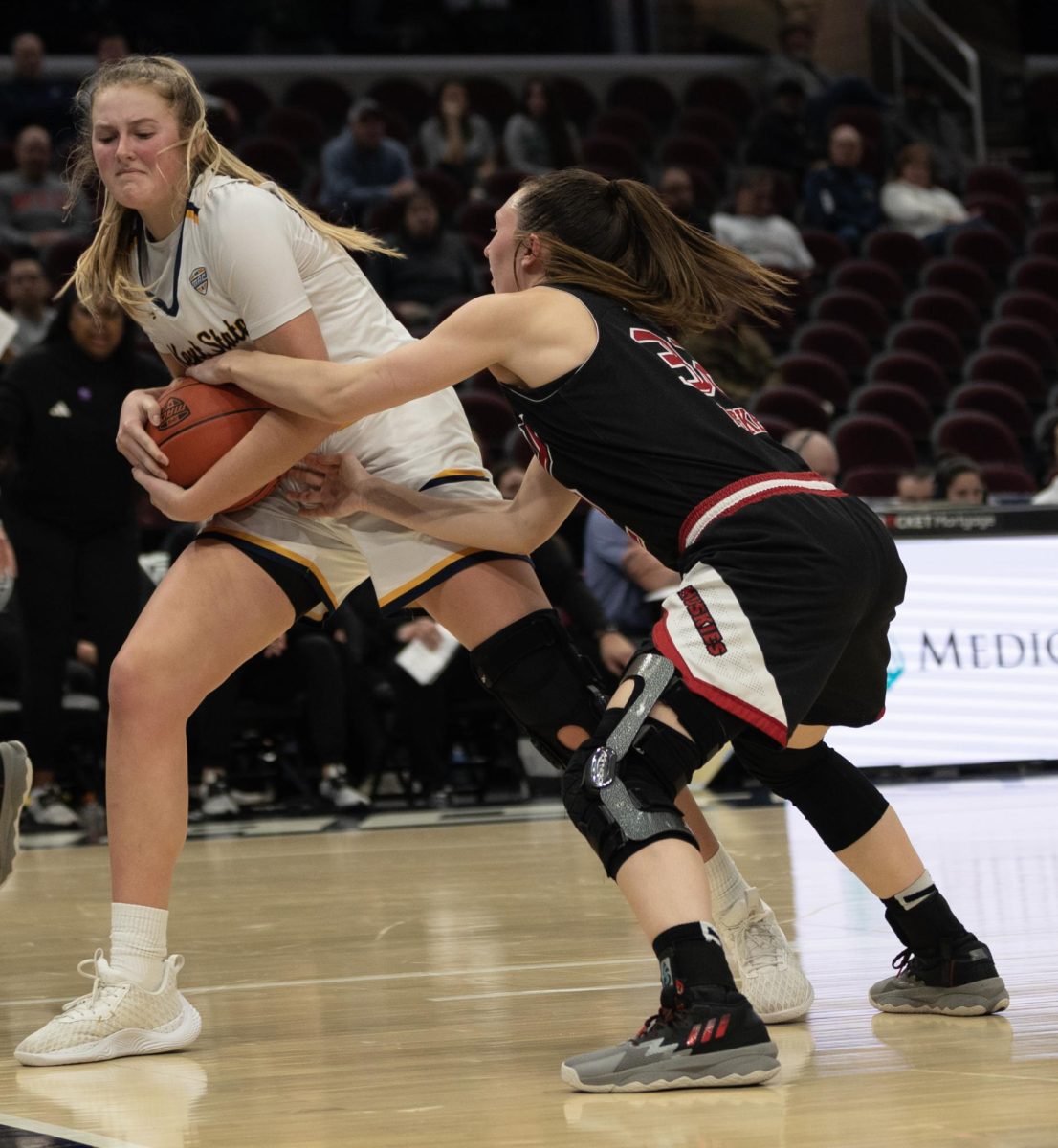 Graduate Student Center Mikala Morris pulls the ball away during a tie-up from Northern Illinois Laura Nickel during their Mid-American Conference Quarterfinal game on March 13, 2024.