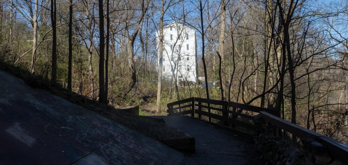 The Franklin Mills Riveredge Trail begins underneath the Haymaker Parkway Bridge and passes by the Silk Mill building on River Street. Photo taken on March 28, 2024.