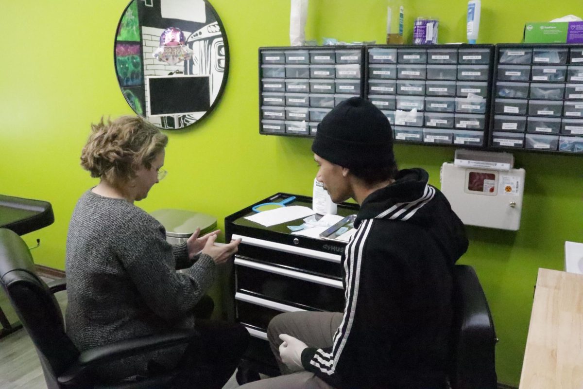 Gail Cowley prepares for her piercing appointment with piercer Aaron Bohn at Defiance Tattoos on March 21, 2024. The tattoo parlor is located at 121 E Main St.