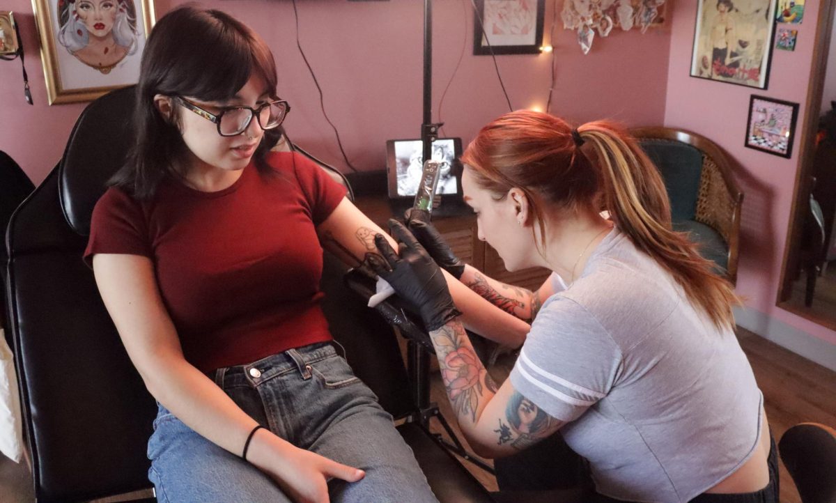 Tattoo artist Erin Haineys works on a tattoo for Lilli at Rotten Peaches Studio on March 21, 2024. Rotten Peaches Studio is located 1480 S Water St.