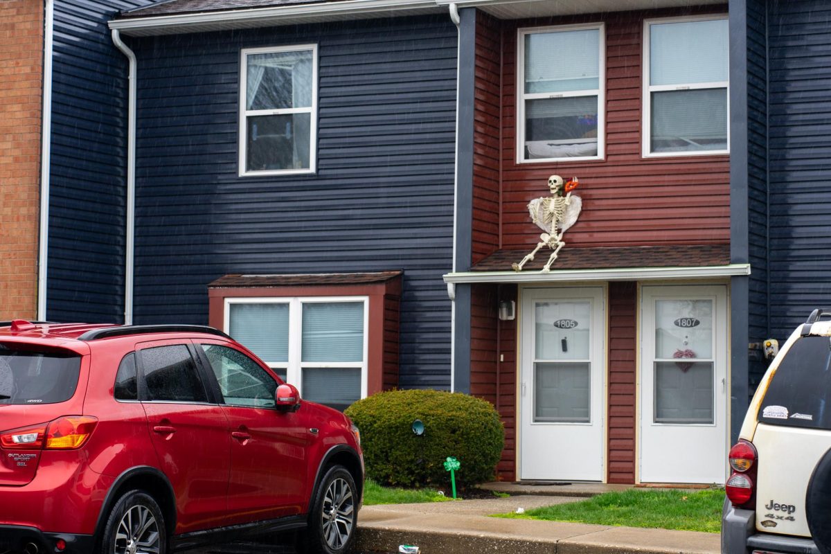 A skeleton decoration sits on the exterior of one of the townhomes at University Townhomes.