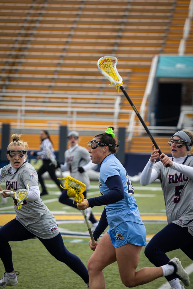 Sophomore Peyton Gellin runs the ball downfield during the game against Robert Morris on March 23, 2024.