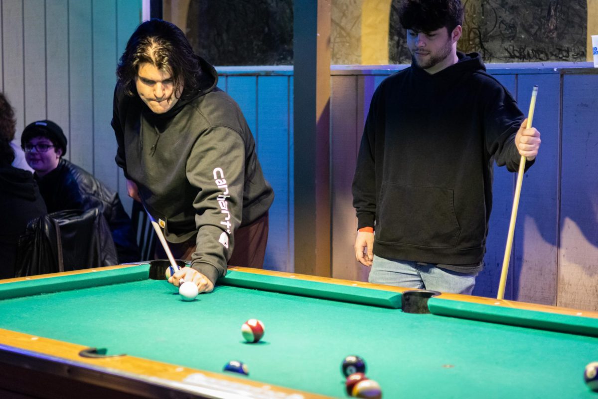 Emmanuel Colom and Gavin Douglas play pool at the Burnt Pickle on March 20, 2024.