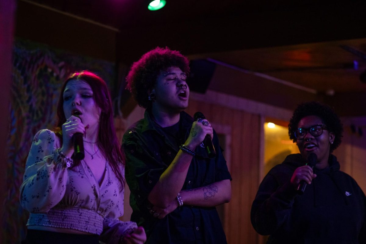 Karaoke night regulars Audreaina Robinson, Marysa Clark, and L Schmidt sing Teenage Dirbag at the Burnt Pickle on March 20, 2024.