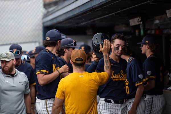 The baseball team congratulate senior Michael McNamara in the dugout after making a run during the game against Bowling Green on April 28, 2024.