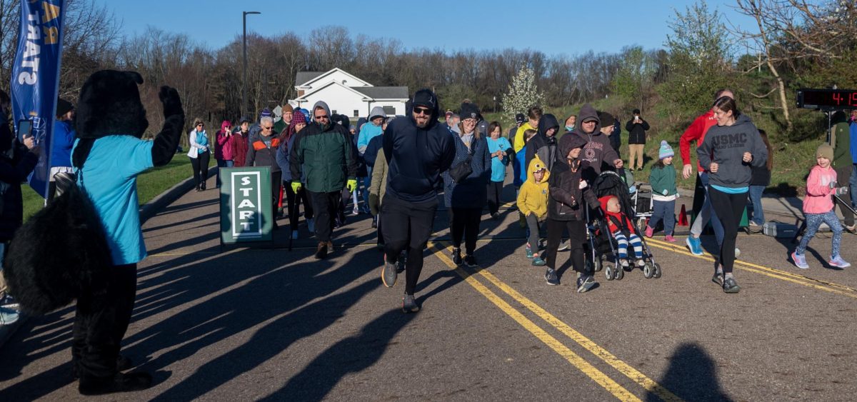 Sam the Black Squirrel cheers on the start of the walkers, rollers and some runners at the Black Squirrel 1-Mile Walk/Roll/Run, done concurrently with the 5k, on April 13, 2024.