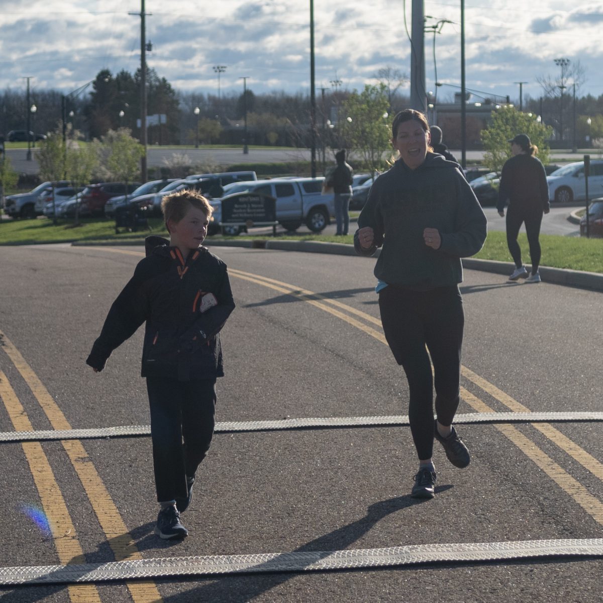 Two people finish the Black Squirrel 5k and 1-Mile Walk/Roll/Run on April 13, 2024