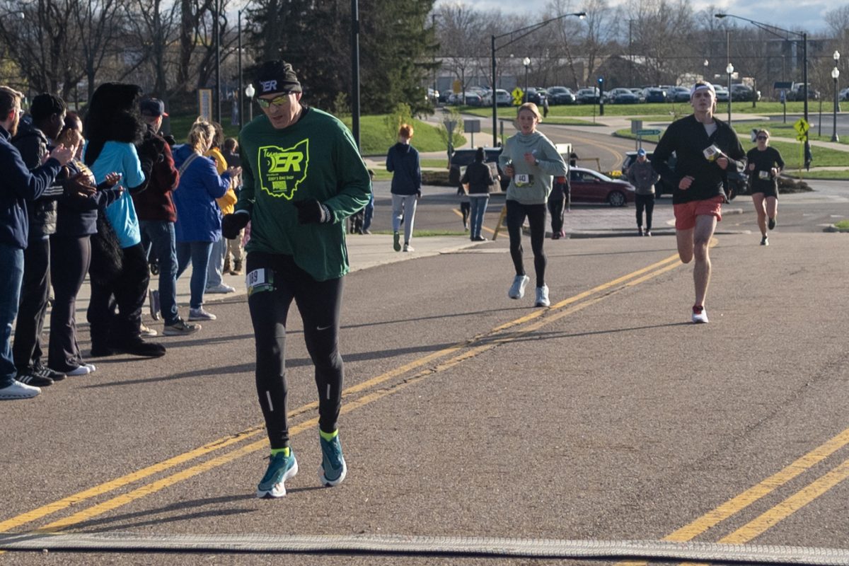 Scott Orlando finishes the Black Squirrel 5k in 40th place, with Adam Resnick and Rebecca Tomko in pursuit on April 13, 2024.