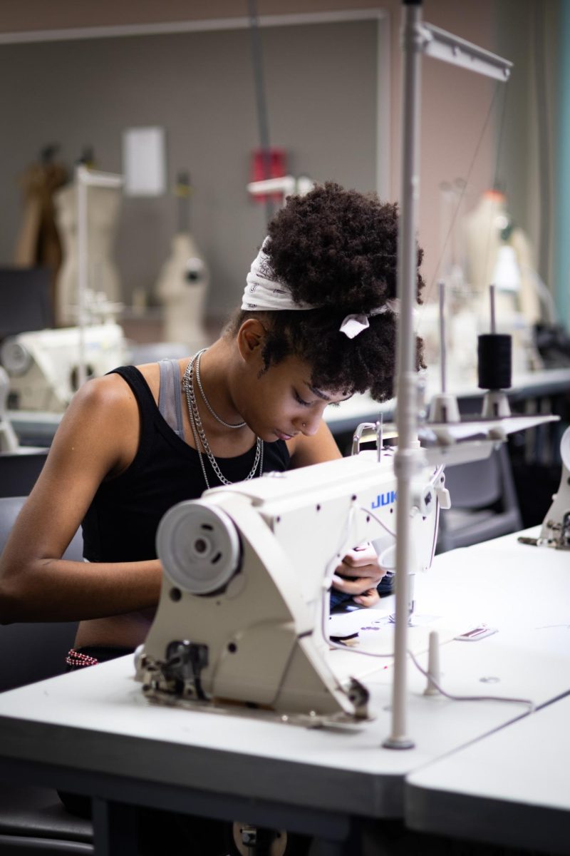Reagan Holtzman, Kent State junior fashion design major, works in the junior studio at a sewing machine on April 18, 2024.