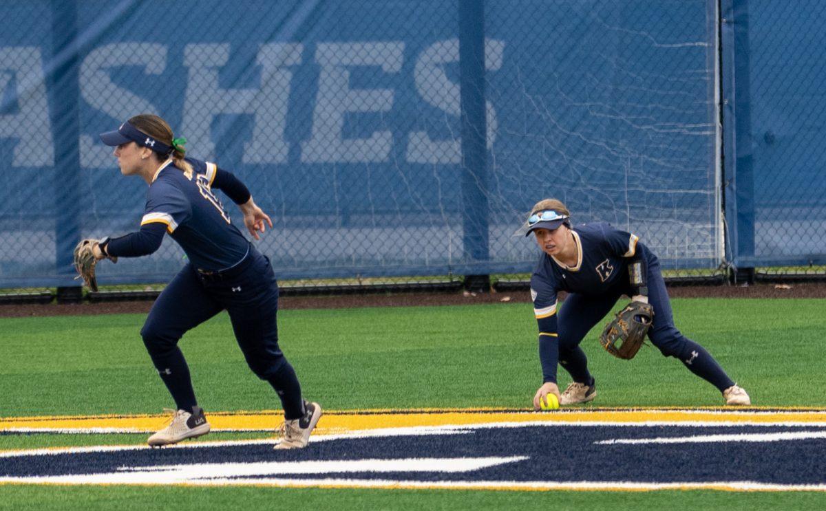 Graduate student shortstop Julia Mazanec picks up a ground ball in mid center field during the Golden Flashes 7-1 loss to the Bobcats in Game 1 on April 2, 2024.
