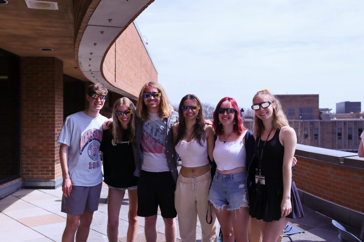 A group of Kent State students gather on the balcony of the Student Center before the solar eclipse on April 8, 2024.