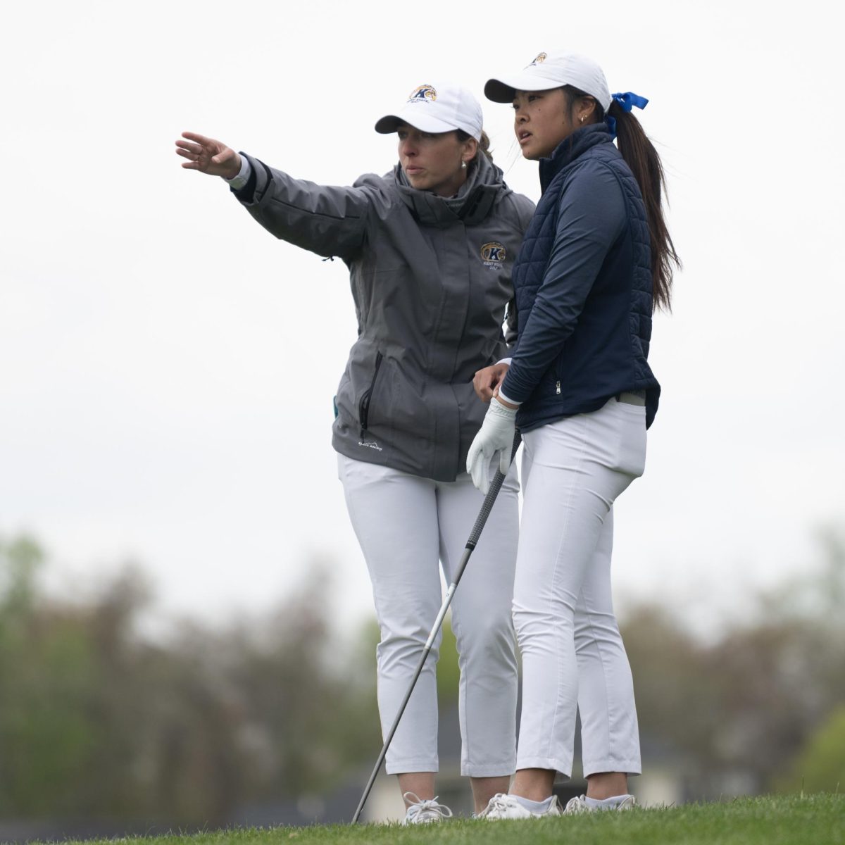 Junior Jennifer Gu, right, and Assistant Coach Manuela Carbajo Ré, survey the approach on the fourth hole at the final round of the Mid-American Conference Championships in Grove City, OH, on April 24, 2024.