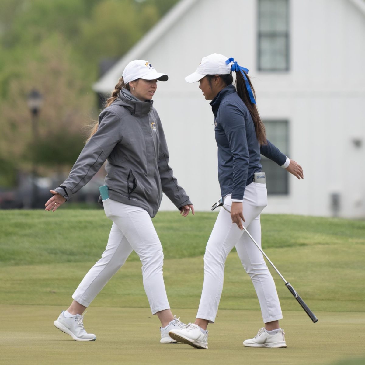 Junior Jennifer Gu, right, low fives Assistant Coach Manuela Carbajo Ré, after a successful putt on the fourth hole at the final round of the Mid-American Conference Championships in Grove City, OH, on April 24, 2024.