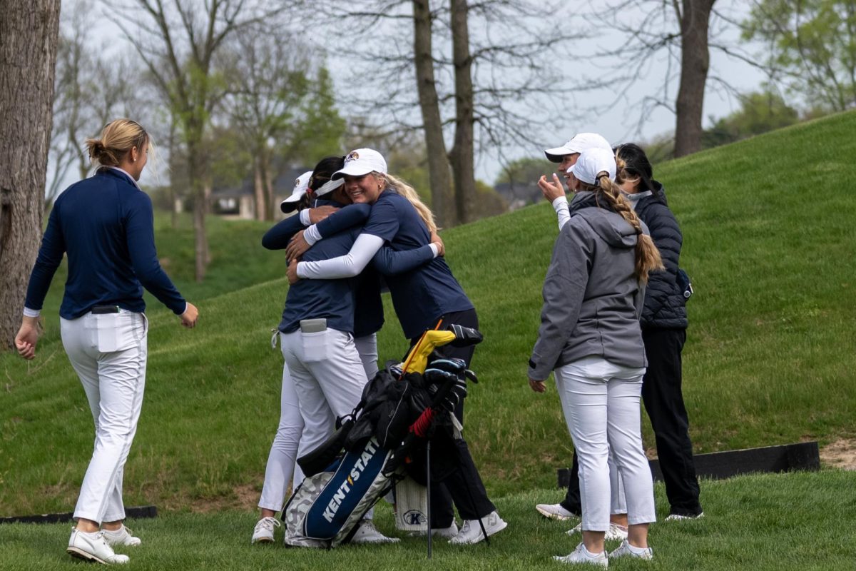 Kristen Belden, center, and another teammate hug Leon Takagi after Takagis putt on 18 following the final round of the Mid-American Conference Championships in Grove City, OH, on April 24, 2024.